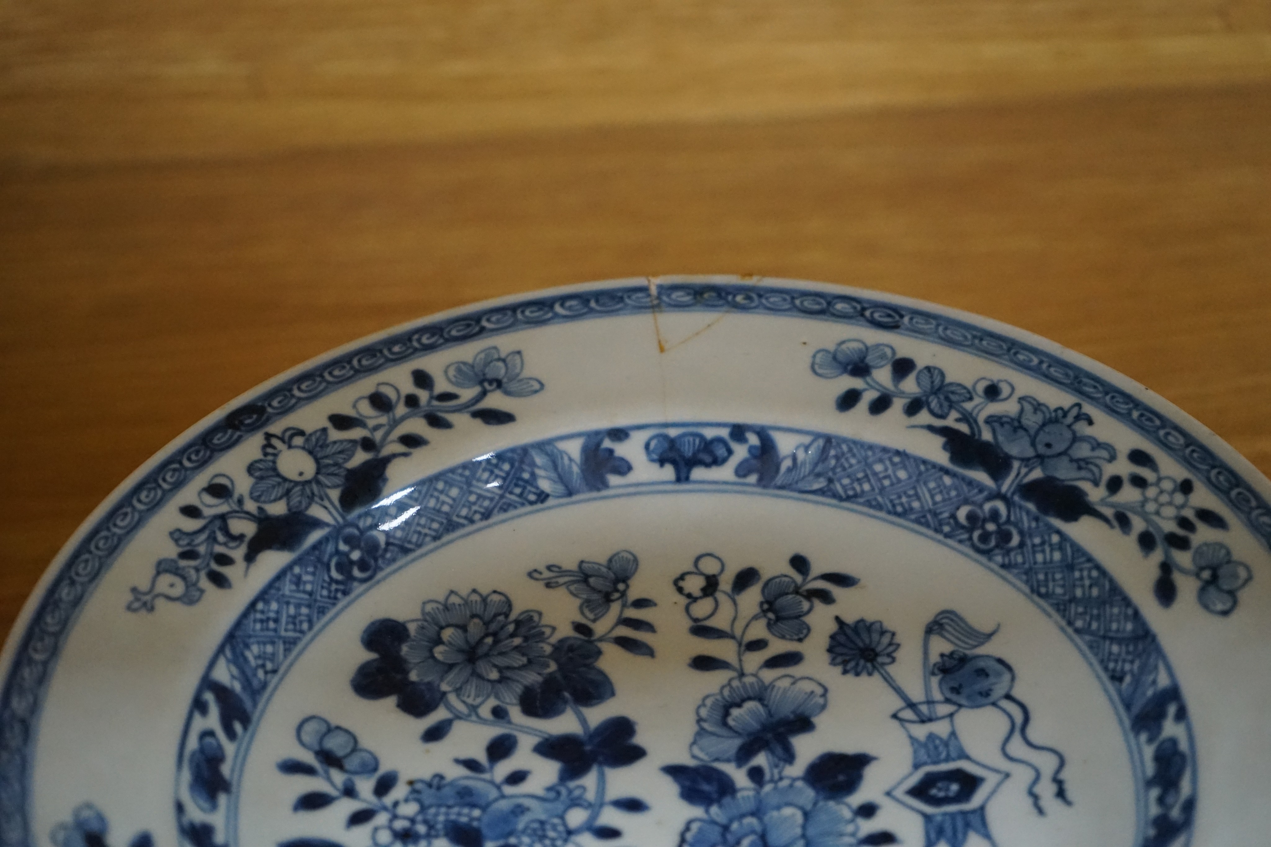 An 18th century Chinese Export blue and white octagonal tureen and cover, decorated with birds and flowers, a pair of similar sauceboats and five plates decorated with urns of flowers